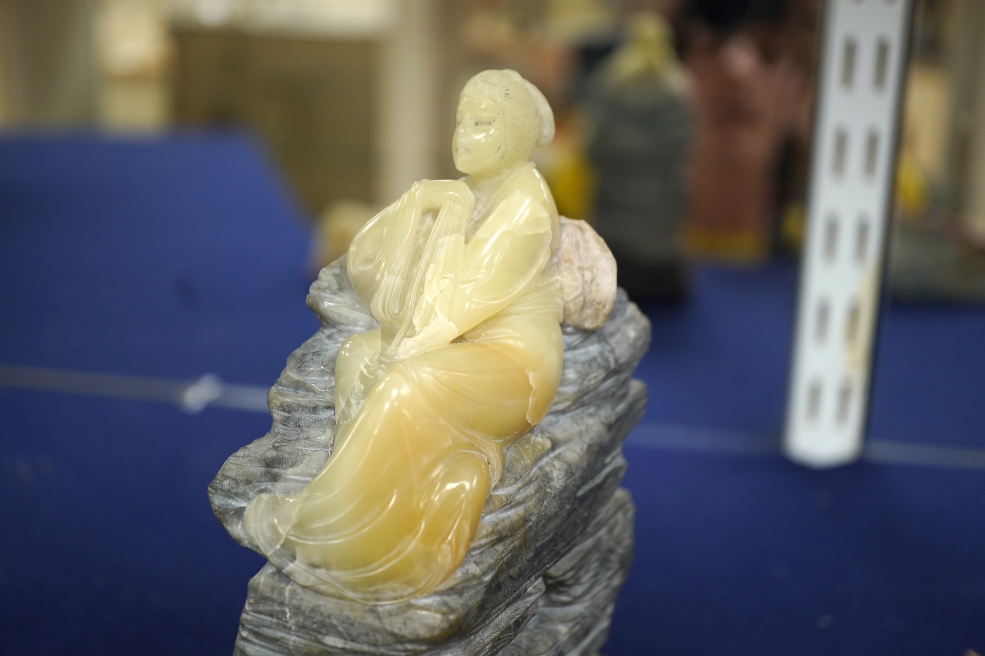 Three Chinese Shoushan stone figures of ladies and an associated stand, tallest 14cm